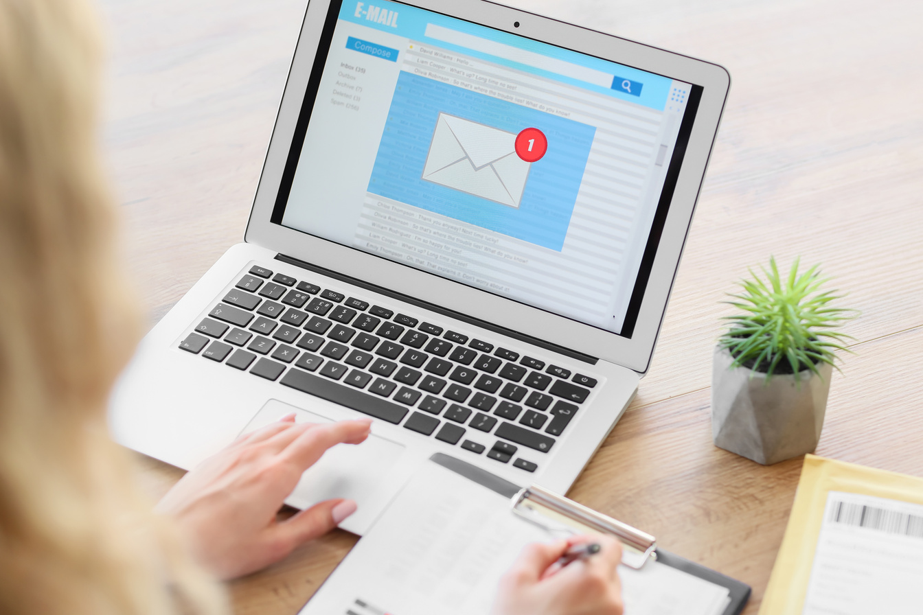 Woman with Laptop Checking Her E-Mail at Home